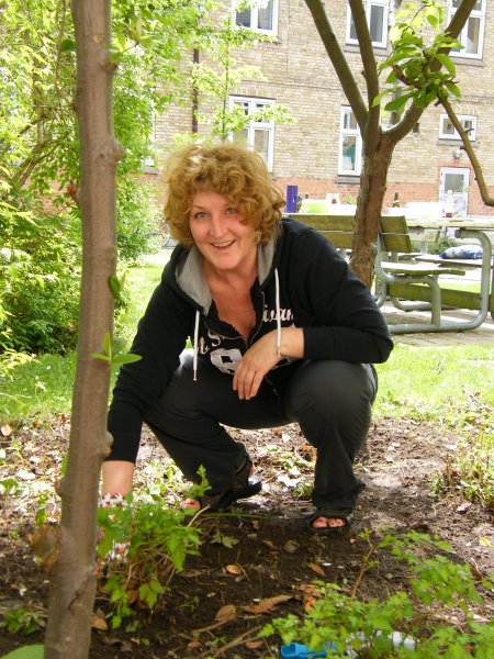 Hanne gør jorden klar til blomster